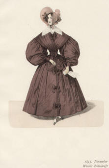 "1834, November, Wiener Zeitschrift". Die handkolorierte Graphik zeigt eine elegante Dame mit enger Wespentaille in der Mode der Biedermeierzeit.